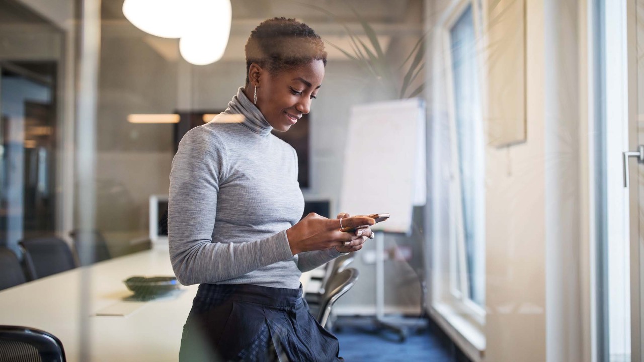 Businesswoman in conference room with phone